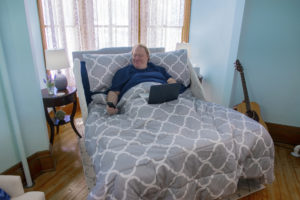 Valiant heavy duty bariatric bed with head up and user on laptop